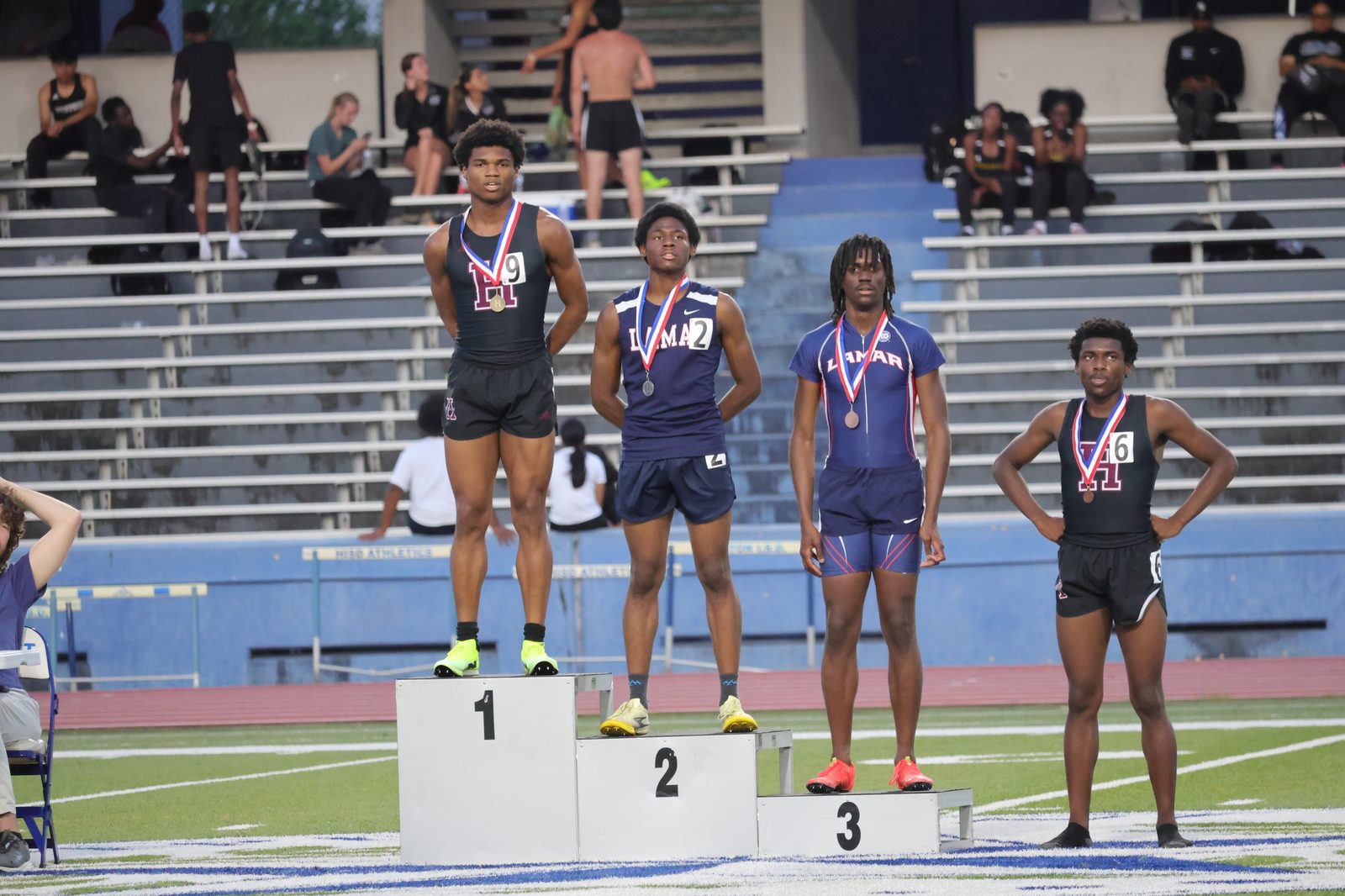 Christian C. Ferguson in his Houston Heights singlet wearing his medal beside the podium after the 800m